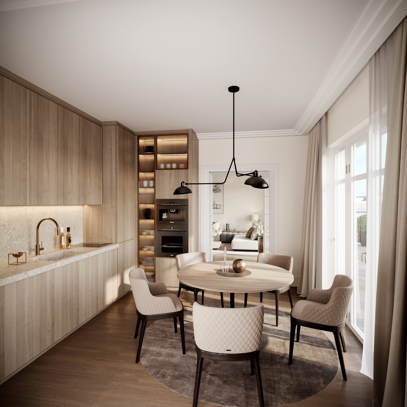 Küche mit Holzfronten und rundem Esstisch mit Polsterstühlen in einer Residence